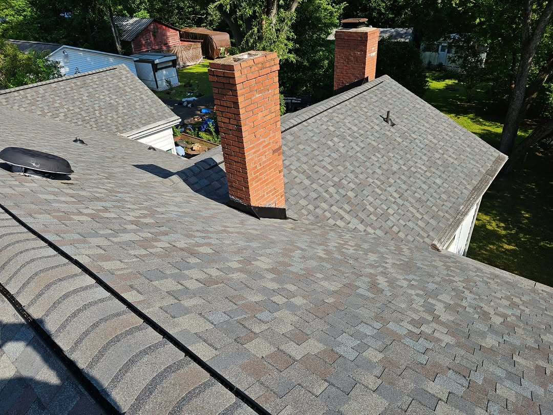 Completed residential roof and chimney installation
